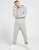 A man is posing in a grey Nike tracksuit. Produktbild-Vorschau