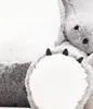 A close-up of a large, plush teddy bear's paw and part of its body. Anteprima dell’immagine prodotto