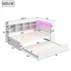 A diagram showing the dimensions of a white daybed with a pull-out trundle and built-in shelving, illuminated by pink LED lights. Produktbild-Vorschau