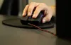 A hand is using a computer mouse on a desk. Anteprima dell’immagine prodotto