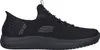 A black Skechers slip-on shoe is shown from the side against a white background. Voir les images du produit