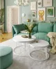 A living room with a green couch, coffee tables, and wall art. Náhľad obrázku produktu