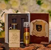 A perfume gift set with a bottle of eau de parfum and a deodorant spray, presented in a decorative box, with flowers and wood chips in the background. Anteprima dell’immagine prodotto