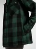 Close-up of a person wearing a green and black plaid shirt. Podgląd zdjęcia produktu