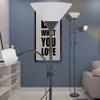 A modern living room with a floor lamp and a bookshelf. Anteprima dell’immagine prodotto