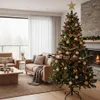 A decorated Christmas tree with a toy train set around its base in a living room. Podgląd zdjęcia produktu