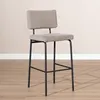 A bar stool is shown in a room with a light-colored wall and wooden floor. Produktbild-Vorschau