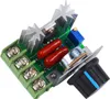 A close-up view of an electronic circuit board with various components, including heatsinks, capacitors, a potentiometer, and a rotary knob, set against a white background. Voir les images du produit
