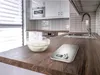 A kitchen counter with a digital scale and a bowl of flour. Anteprima dell’immagine prodotto