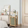 A wooden shelf unit with a laundry basket next to a dresser with framed artwork. Produktbild-Vorschau
