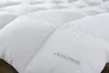 Close-up of a white quilted comforter or duvet. Produktbild-Vorschau