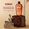 A bottle of Tabac Original Shower Gel is displayed on rustic wooden blocks, with some greenery. Podgląd zdjęcia produktu