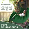 A person relaxing in a green hammock chair on a balcony with plants and a railing. Produktbild-Vorschau