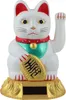 A white Maneki-neko (lucky cat) figurine with a gold coin and a solar panel on its base, set against a white background. Produktbild-Vorschau