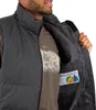 A man is wearing a black vest, and the inside pocket is open, showing a label. Produktbild-Vorschau