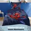 A Spiderman-themed duvet cover and pillowcase set displayed on a bed in a child's room. Produktbild-Vorschau
