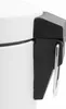 A close-up shot of the side of a white trash can, showing a black plastic handle mechanism with a silver ring. Náhled obrázku produktu