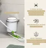 A bathroom scene showing a white trash can mounted on a wall with a mop cleaning the floor. Náhled obrázku produktu
