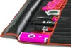 A tool roll bag with various tools laid out inside, including a level, brushes, scissors, and a utility knife. Produktbild-Vorschau