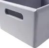 A close-up view of a gray wooden storage box with a cutout handle. Produktbild-Vorschau
