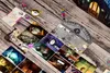 A collage of cards and game pieces arranged on a wooden surface. Podgląd zdjęcia produktu