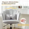 A close-up of a gray office chair with a decorative back and a small pillow, set against a blurred background of a vanity table with bottles. Produktbild-Vorschau