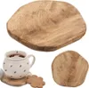 A collage of wooden coasters and a mug with a cookie. Produktbild-Vorschau
