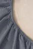 A close-up view of a gray fitted sheet with elastic edging. Produktbild-Vorschau