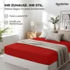 A bedroom scene with a red bed sheet. Produktbild-Vorschau