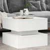 A white coffee table in a living room setting with a couch in the background. Produktbild-Vorschau