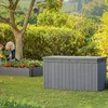 A garden scene with two people tending to plants next to a storage box. Voir les images du produit