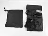 Two black fabric items, one folded and bagged, the other unfolded and showing straps and buckles, laid out on a white surface. Náhled obrázku produktu