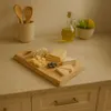 A cheese board with various cheeses and blueberries on a kitchen counter. Anteprima dell’immagine prodotto