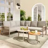 An outdoor patio setting with a sectional sofa, coffee tables, and decorative elements. Produktbild-Vorschau