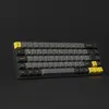 A black mechanical keyboard with yellow and gray keys is displayed against a black background. Produktbild-Vorschau