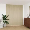 A room interior with a large beige curtain covering a wall, a potted plant, and a dresser. Produktbild-Vorschau