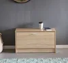 A shoe cabinet with a coffee cup and a book on top, placed against a gray wall. Náhľad obrázku produktu