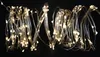 A strand of fairy lights with many small, warm white LEDs on a silver wire, against a black background. Náhľad obrázku produktu