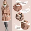 A woman wearing a brown hooded blanket with white trim, with close-up shots highlighting features. Produktbild-Vorschau
