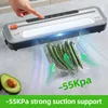 A vacuum sealer is being demonstrated with okra being sealed in a bag. An avocado half is visible in the foreground. Podgląd zdjęcia produktu