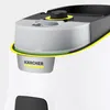 Close-up of the top of a white and black cleaning appliance with a transparent water reservoir and yellow and green accents. The Kärcher logo is visible on a silver component. Voir les images du produit
