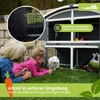 Two children are interacting with rabbits in front of a two-story rabbit hutch. Produktbild-Vorschau