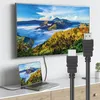 A laptop is connected to a large TV via an HDMI cable, displaying the same landscape image on both screens. Voir les images du produit
