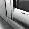 A close-up view of a shower enclosure, focusing on the base and a curved glass panel. Voir les images du produit