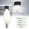 A bedroom scene with a bedside table and lamp, featuring a close-up of an LED light bulb. Produktbild-Vorschau