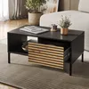 A modern living room setting with a black coffee table featuring a wooden slatted drawer. Náhled obrázku produktu
