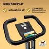Close-up of the handlebars and display of a stationary bike, with marketing text and logos. Produktbild-Vorschau