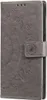 A close-up of a gray flip phone case with a mandala pattern embossed on it. Produktbild-Vorschau