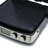 A close-up, angled view of a black and silver electric grill on a white background. Produktbild-Vorschau