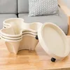 A stack of cream-colored vertical planters with a rolling base on a wooden table, with a couch and pillow in the background. Voir les images du produit